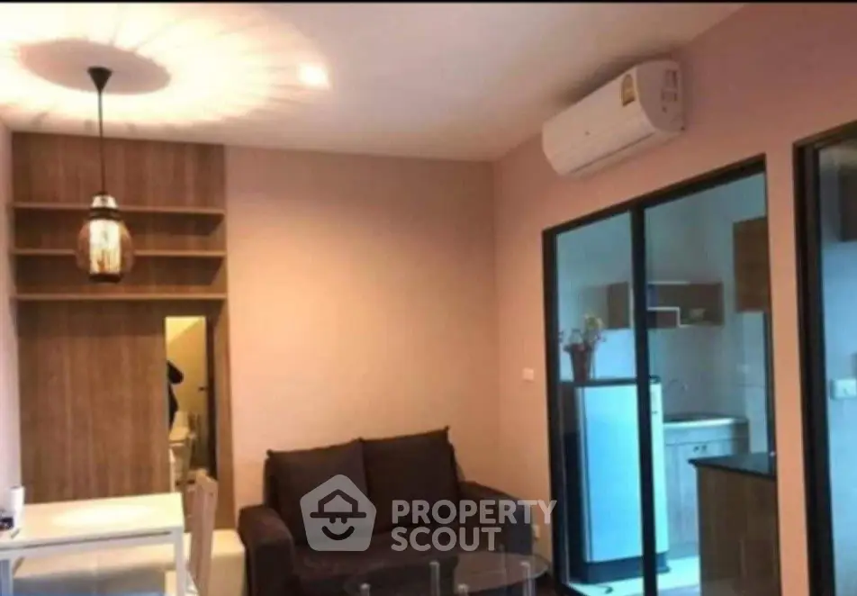 Modern living room with cozy sofa and stylish lighting in an open layout apartment.