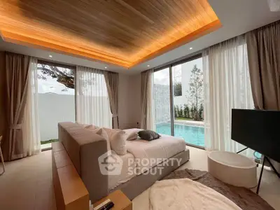 Luxurious bedroom with pool view and modern decor in a stunning real estate property.