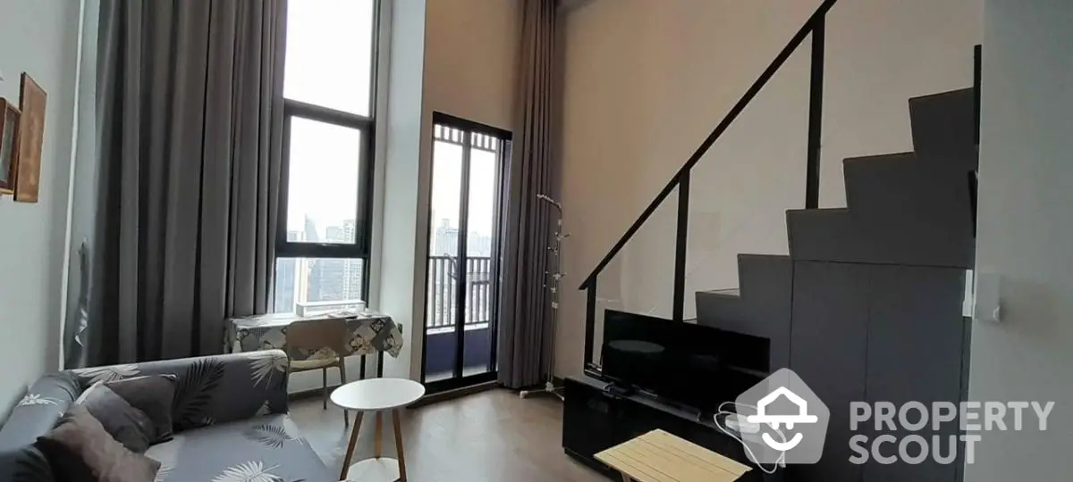 Modern loft apartment with high ceilings and city view balcony