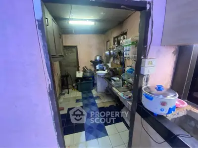 Cozy kitchen with eclectic decor and essential appliances, perfect for compact living spaces.