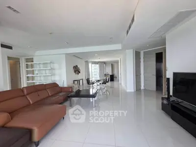 Spacious modern living room with sleek furniture and large windows offering natural light.