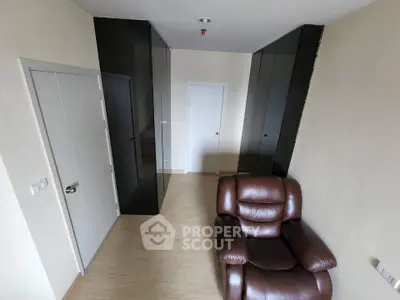 Compact study room with leather chair and sleek black cabinets