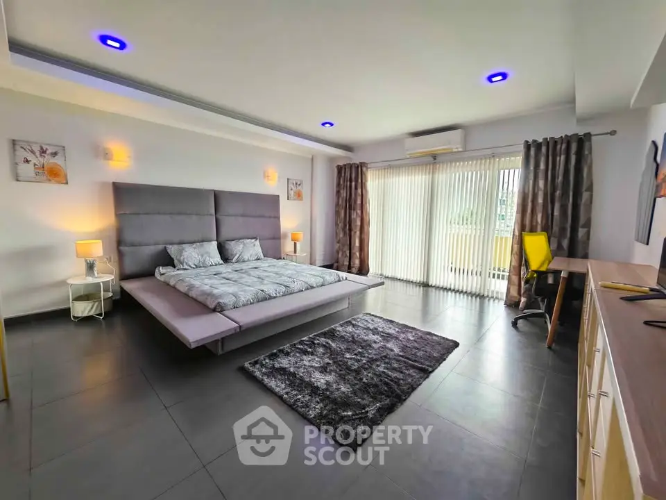 Spacious modern bedroom with sleek design and natural light
