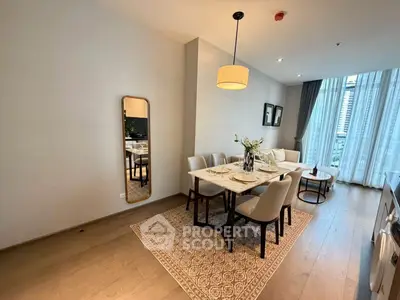 Elegant dining area with modern decor and large windows in a stylish apartment.