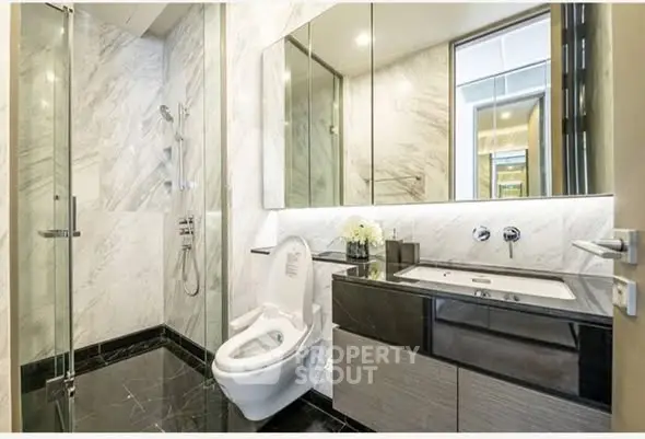 Luxurious modern bathroom with marble walls and sleek fixtures