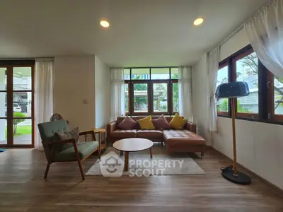 Spacious living room with modern furniture and large windows offering natural light