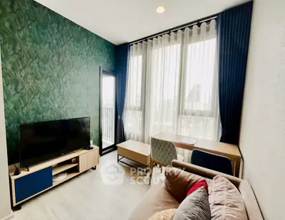 Modern living room with stylish decor and large windows offering city views