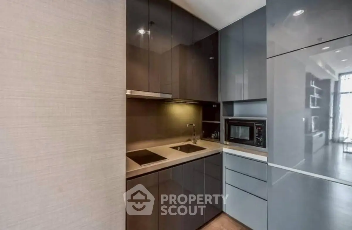 Modern kitchen with sleek cabinetry and built-in appliances in a contemporary apartment.
