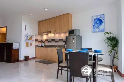 Spacious kitchen with modern appliances and a sleek dining area, featuring ample cabinet space and a bright, inviting atmosphere.