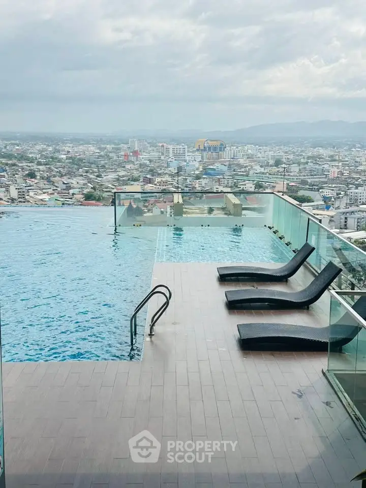 Stunning rooftop infinity pool with panoramic city views and modern lounge chairs.