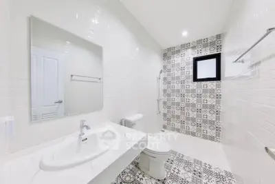 Modern bathroom with stylish patterned tiles and sleek fixtures