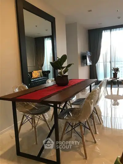 Modern dining area with stylish table and chairs in a bright living room.