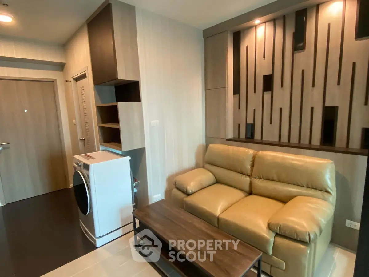 Modern living room with stylish decor and washing machine in a cozy apartment.