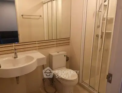 Modern bathroom with shower and sleek fixtures in a contemporary apartment.