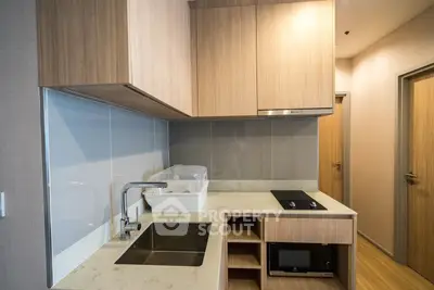 Modern kitchen with sleek cabinetry and built-in appliances in a stylish apartment.