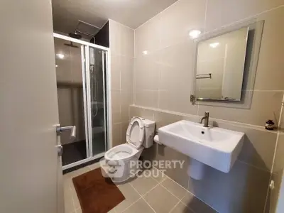 Modern bathroom with sleek fixtures and glass shower enclosure