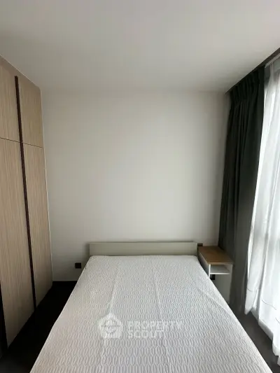 Modern bedroom with minimalist design, featuring a cozy bed and sleek wardrobe, perfect for urban living.