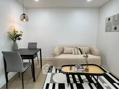 Modern living room with stylish furniture and elegant decor, featuring a cozy sofa and chic dining area.