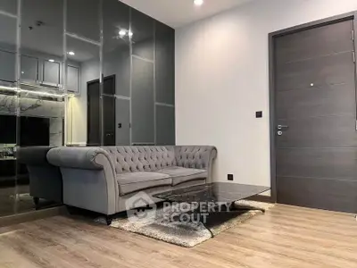 Modern living room with elegant gray sofa and sleek marble coffee table.