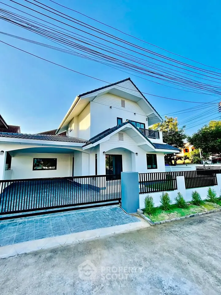 Stunning modern two-story house with sleek design and spacious driveway.