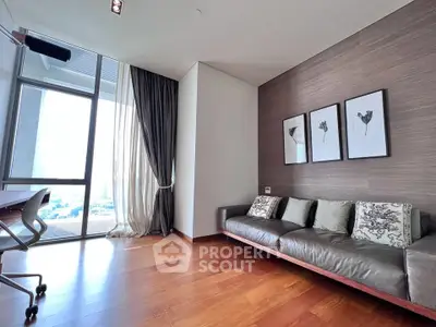 Modern living room with wooden flooring, stylish sofa, and large window with city view.