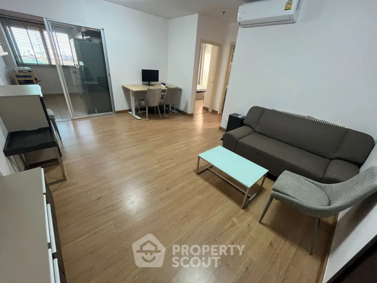 Modern living room with wooden flooring and stylish furniture in a cozy apartment.