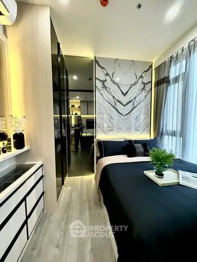 Luxurious modern bedroom with elegant decor and large windows offering natural light.