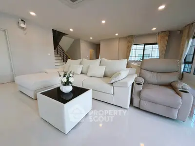 Spacious modern living room with elegant white furniture and natural light