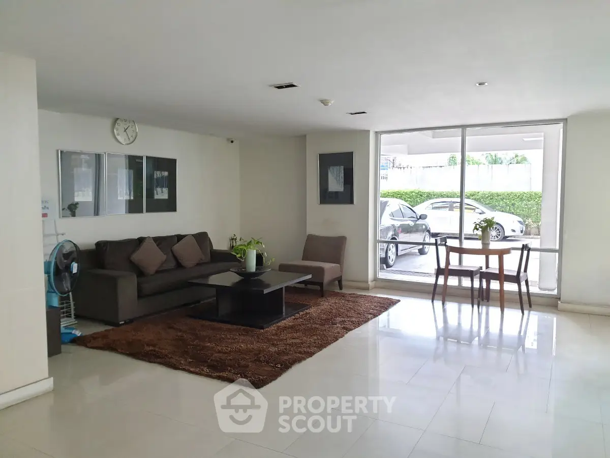 Spacious modern lobby with cozy seating and large windows offering natural light.