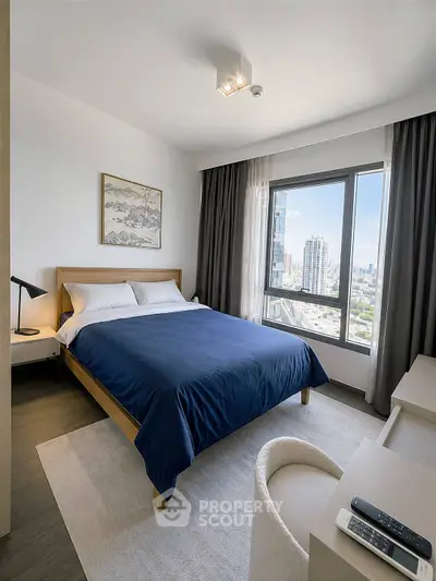 Modern bedroom with city view, featuring a cozy bed and stylish decor in a high-rise apartment.
