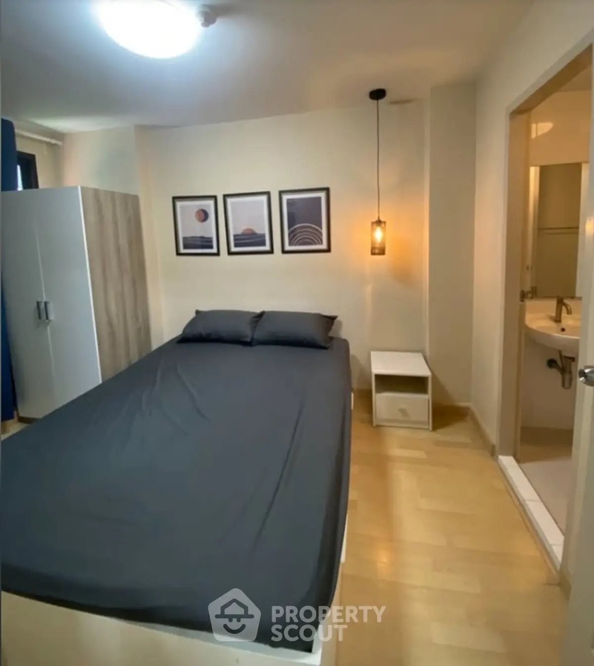 Cozy bedroom with modern decor and ensuite bathroom in stylish apartment