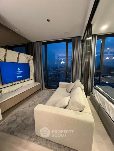 Luxurious living room with city view, modern decor, and cozy seating in high-rise apartment.