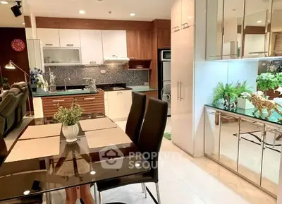 Modern open-layout kitchen and dining area with sleek design and stylish decor.