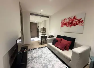 Modern living room with stylish decor and open kitchen layout in a cozy apartment.