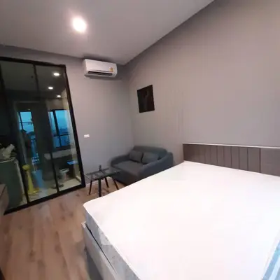 Modern bedroom with ensuite bathroom and sleek furnishings in a stylish apartment.