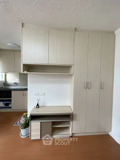 Modern kitchen with sleek cabinetry and built-in appliances in a stylish apartment.