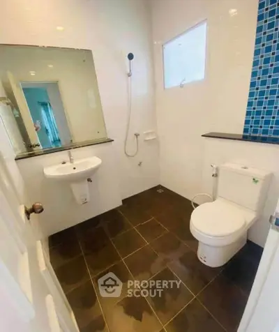Modern bathroom with sleek fixtures and stylish tile accents, perfect for contemporary living.