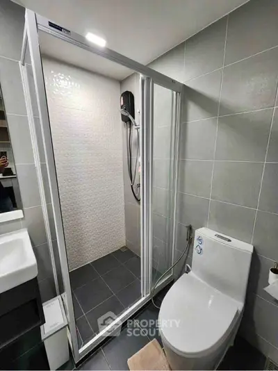 Modern bathroom with sleek shower enclosure and contemporary fixtures.