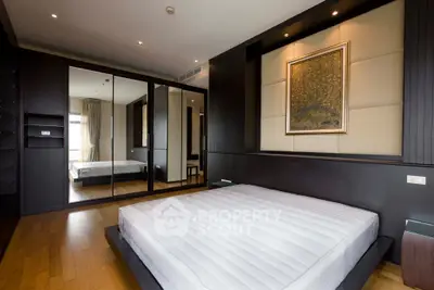 Luxurious modern bedroom with mirrored wardrobe and elegant decor