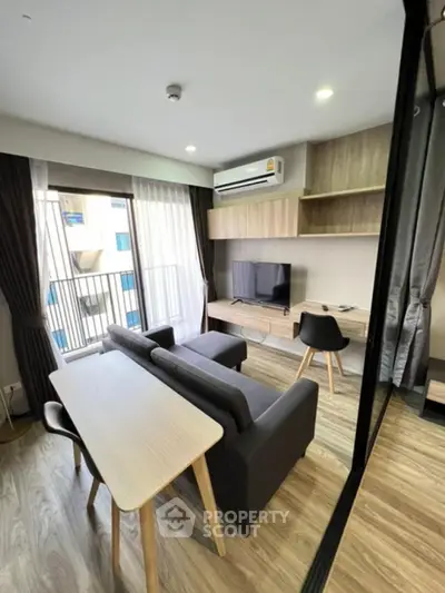 Modern living room with sleek furniture and balcony view in a stylish apartment.