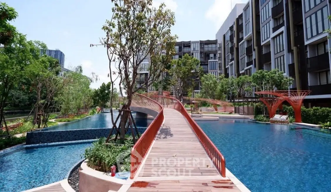 Luxurious modern apartment complex with stunning pool and landscaped gardens.