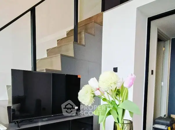 Modern living room with sleek staircase and stylish decor
