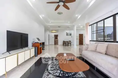 Spacious modern living room with elegant decor and large windows for natural light.