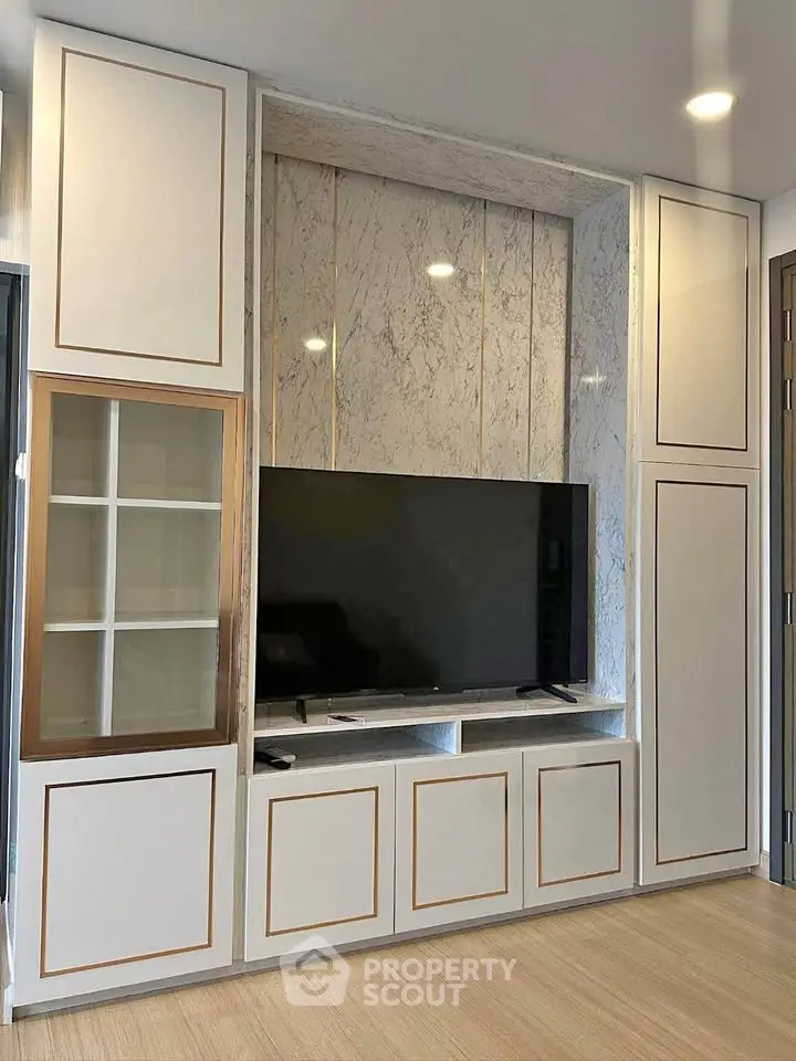 Modern living room with sleek built-in TV cabinet and elegant marble accents