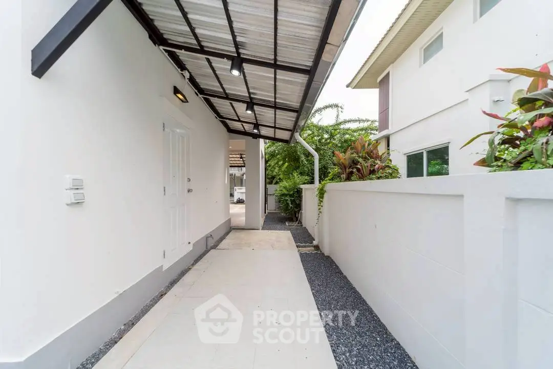Modern exterior walkway with sleek design and lush greenery