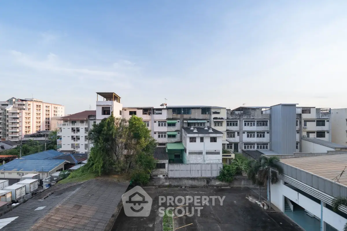 Urban residential buildings with clear sky view, showcasing diverse architecture and greenery.