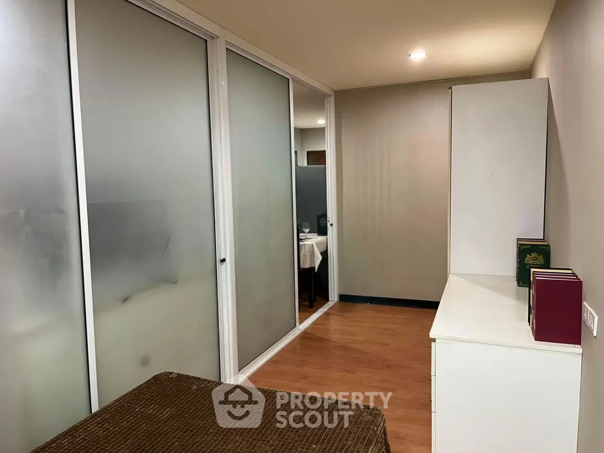 Modern interior with frosted glass sliding doors and wooden flooring