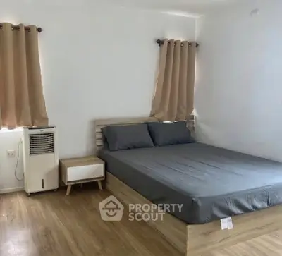 Cozy bedroom with modern wooden bed and stylish curtains, perfect for restful nights.