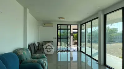 Spacious living room with large windows and garden view