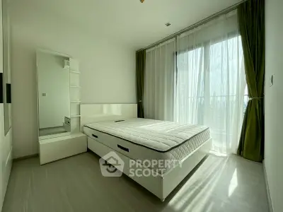 Spacious bedroom with large window and modern decor